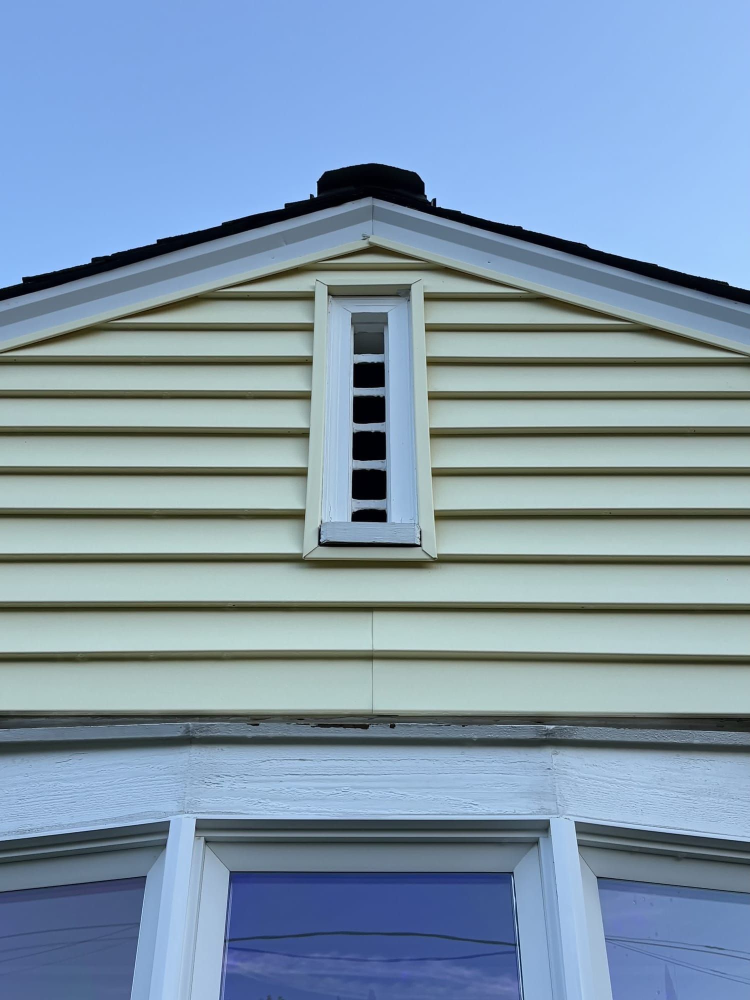Same siding gable after soft wash, stains removed